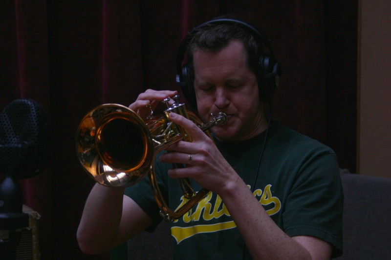 A picture of Erik Jekabson playing a trumpet.