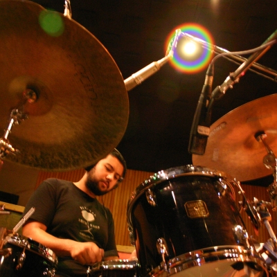 A picture of Hamir Atwall playing the drums.