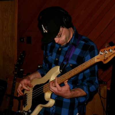 A photograph of Matt Montgomery playing bass in the Wide Hive Studio.