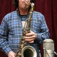 Doug Rowan, of the Wide Hive Players, playing a saxophone. 